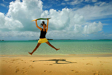 On one of Cook Islands' many sand bars, Eikura, 18, jumps for joy.