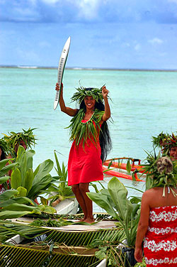 Muri Lagoon. Tina Vogel carries the revolutionary Melbourne 2006 Queen's Baton across the Muri Lagoon during relay celebrations in the Cook Islands.