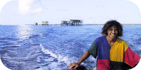Young men driving a boat on a Manihiki Lagoon Pearls Farm